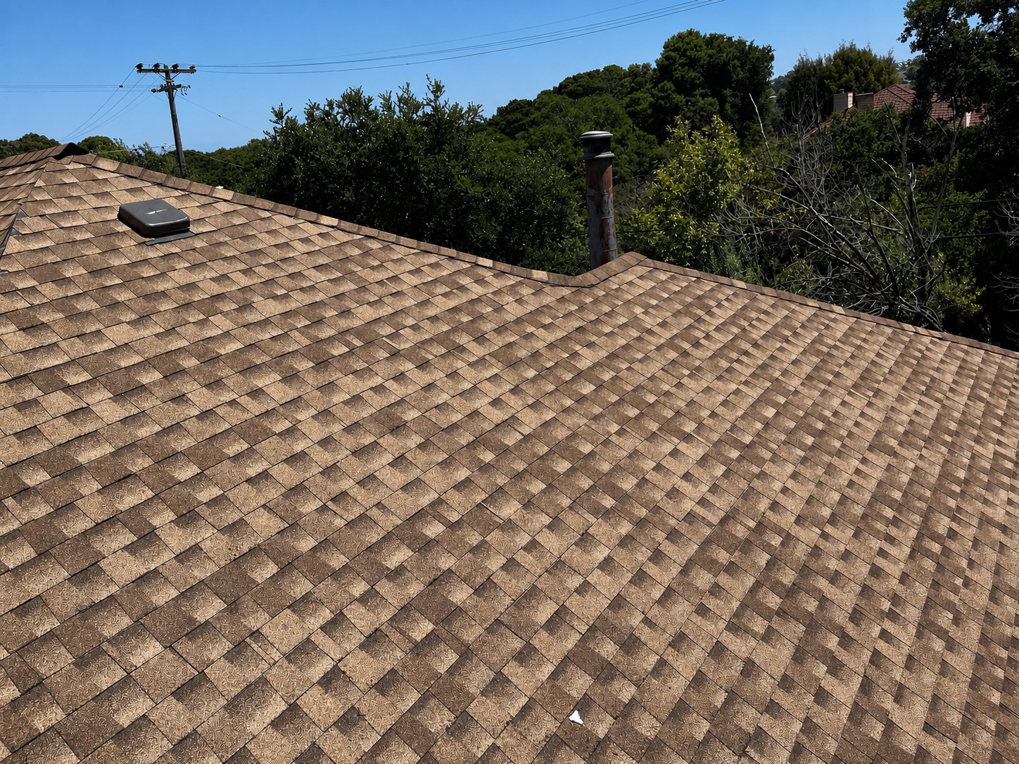 Completed asphalt-shingle roof planes and valley in Belmont